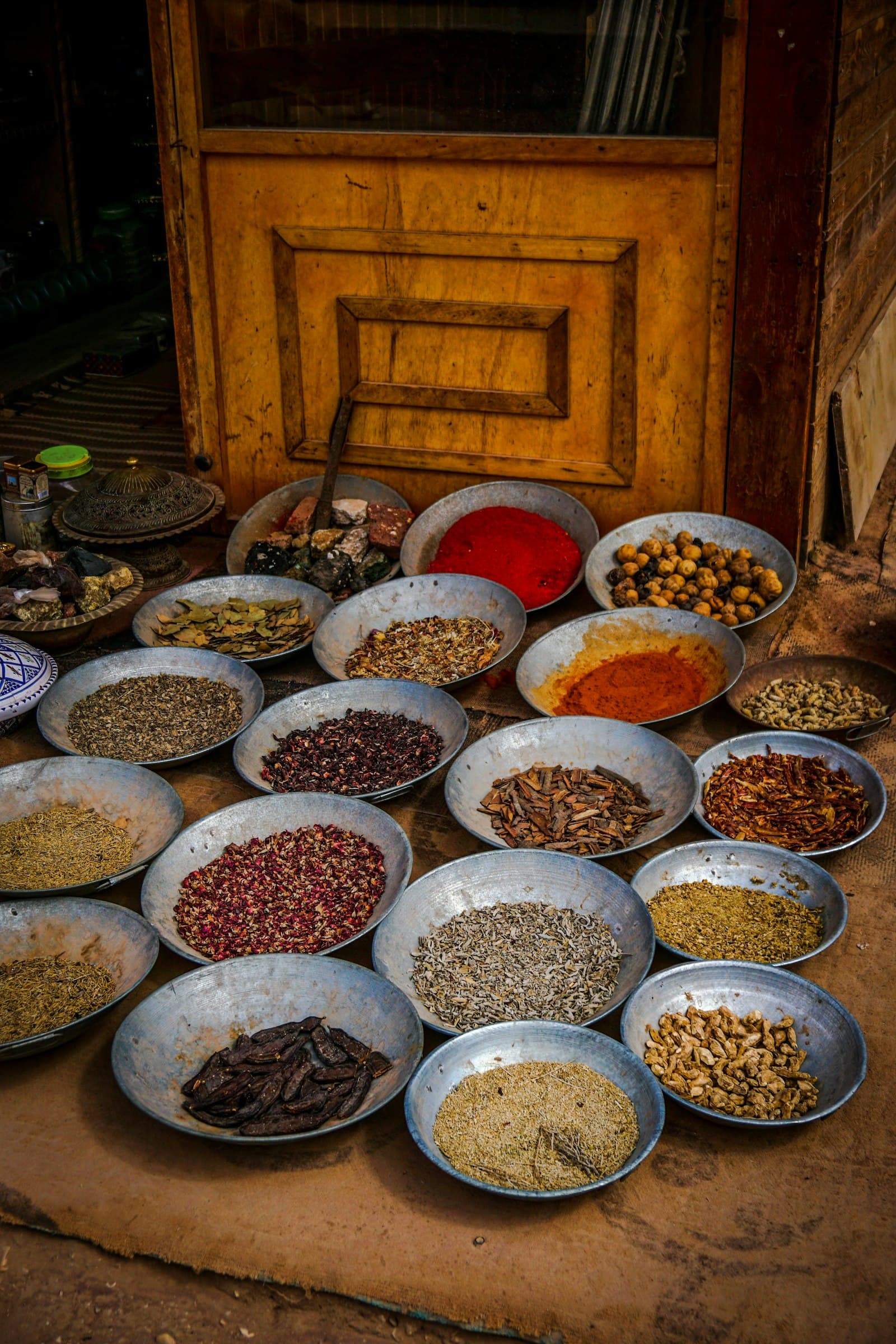 Metal bowls of dried spices and seeds at a spice stall